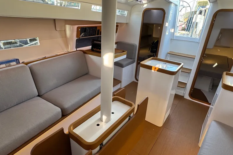 Yacht Photos Pics Modern interior of 2023 Beneteau First 36 sailboat with sleek design and comfortable seating.