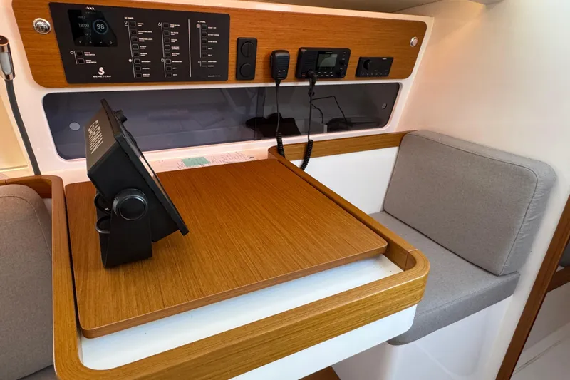  Yacht Photos Pics Navigation station in 2023 Beneteau First 36 yacht, featuring control panel and seating.