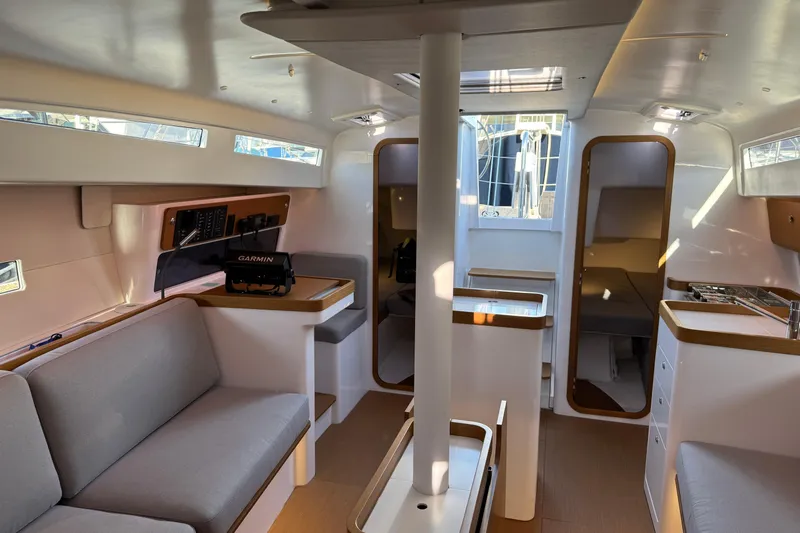  Yacht Photos Pics Modern interior of 2023 Beneteau First 36 sailboat with sleek design and comfortable seating.