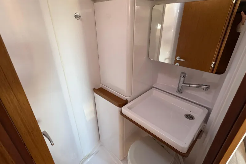  Yacht Photos Pics 2023 Beneteau First 36 yacht bathroom with modern sink and mirror.