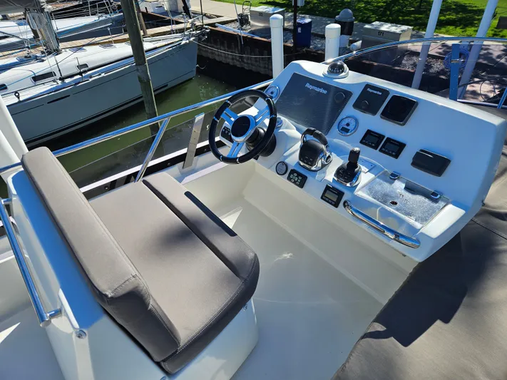 Margie Yacht Photos Pics Helm of a 2018 Prestige 460 yacht docked in marina.