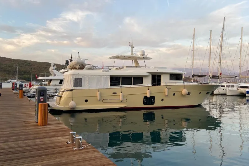  Yacht Photos Pics Luxury 2013 Apreamare 82 yacht docked at marina, surrounded by calm waters and sailboats.