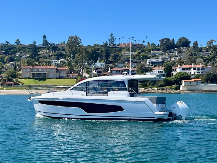 Lupe Di Mare Yacht Photos Pics 2024 Sealine C335V yacht cruising near coastal homes on a sunny day.