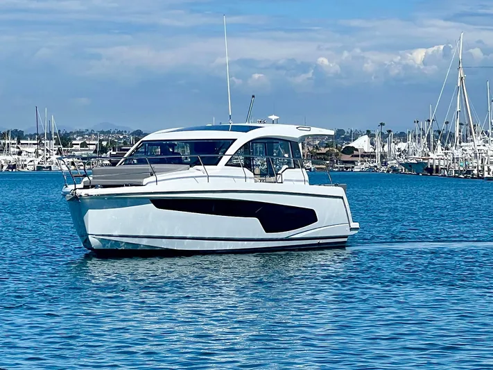 Lupe Di Mare Yacht Photos Pics 2024 Sealine C335V yacht cruising in a marina under a clear blue sky.