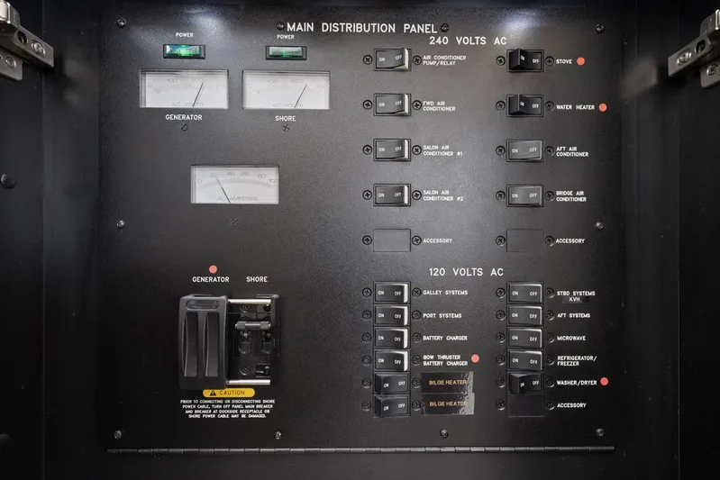 Free Bird Yacht Photos Pics Main distribution panel of 2003 Sea Ray 480 Motor Yacht, showing AC power controls and switches.