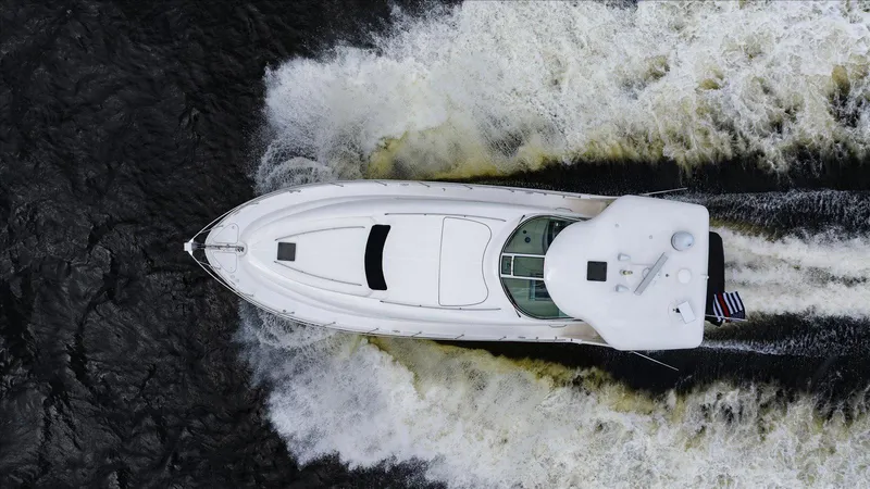 Free Bird Yacht Photos Pics Aerial view of 2003 Sea Ray 480 Motor Yacht cruising on water.