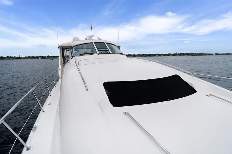 Free Bird Yacht Photos Pics 2003 Sea Ray 480 Motor Yacht on calm water under blue sky.