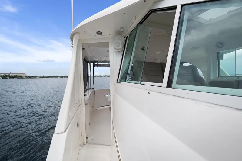Free Bird Yacht Photos Pics 2003 Sea Ray 480 Motor Yacht side view with windows, docked on calm water.