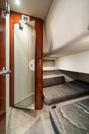 Free Bird Yacht Photos Pics 2003 Sea Ray 480 Motor Yacht interior cabin with twin beds and a full-length mirror.