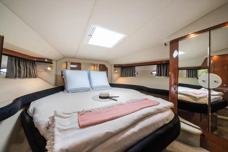 Free Bird Yacht Photos Pics Luxurious bedroom interior of 2003 Sea Ray 480 Motor Yacht with elegant bedding and mirrored closet.