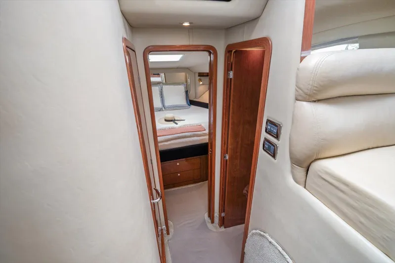 Free Bird Yacht Photos Pics Interior of 2003 Sea Ray 480 Motor Yacht, featuring cozy bedroom and elegant wood finishes.