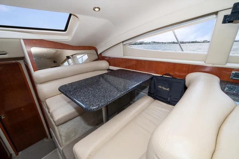 Free Bird Yacht Photos Pics Luxurious interior of 2003 Sea Ray 480 Motor Yacht with elegant seating and table.