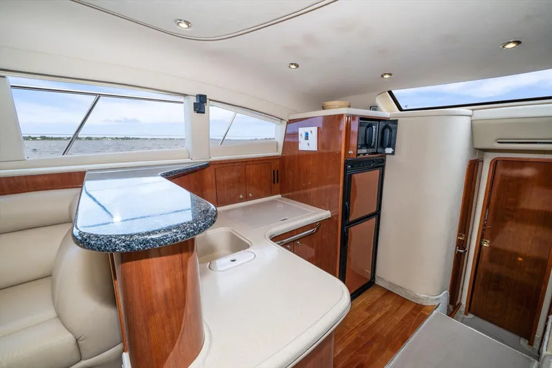 Free Bird Yacht Photos Pics Luxurious interior of 2003 Sea Ray 480 Motor Yacht with modern kitchen and seating area.