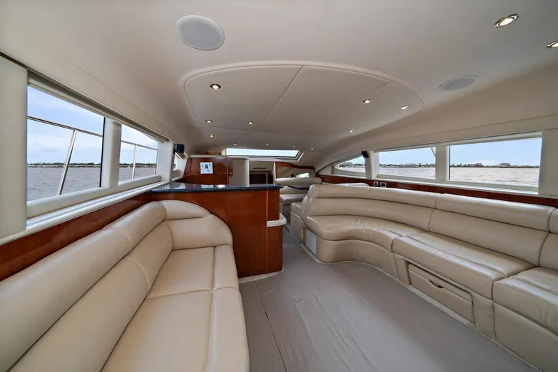 Free Bird Yacht Photos Pics Luxurious interior of 2003 Sea Ray 480 Motor Yacht with beige leather seating and panoramic windows.