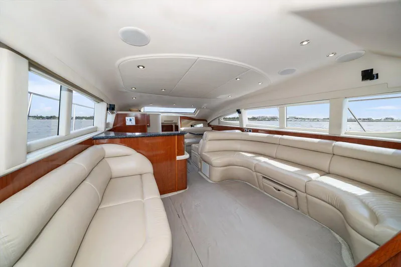 Free Bird Yacht Photos Pics Luxurious interior of 2003 Sea Ray 480 Motor Yacht with plush seating and panoramic windows.