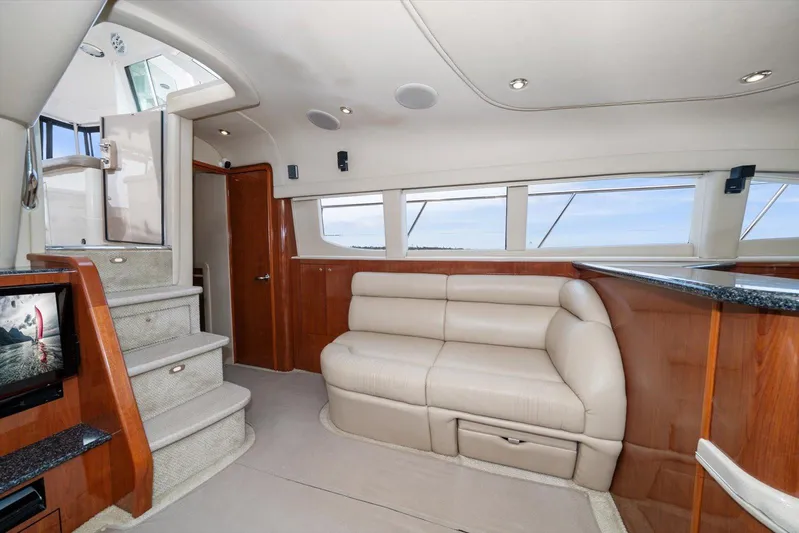Free Bird Yacht Photos Pics Luxurious interior of 2003 Sea Ray 480 Motor Yacht with beige leather seating and modern amenities.
