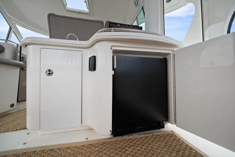 Free Bird Yacht Photos Pics 2003 Sea Ray 480 Motor Yacht interior with open cabinet and black appliance.