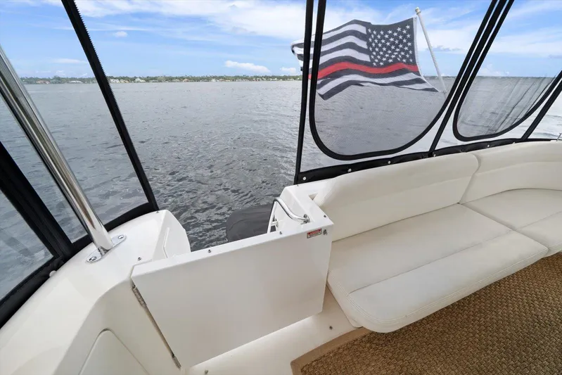 Free Bird Yacht Photos Pics 2003 Sea Ray 480 Motor Yacht interior with American flag, overlooking calm waters.