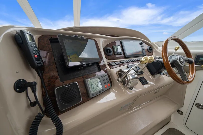 Free Bird Yacht Photos Pics 2003 Sea Ray 480 Motor Yacht helm with navigation controls and wooden steering wheel.