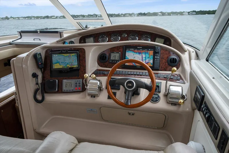 Free Bird Yacht Photos Pics Cockpit of 2003 Sea Ray 480 Motor Yacht with navigation equipment and steering wheel.