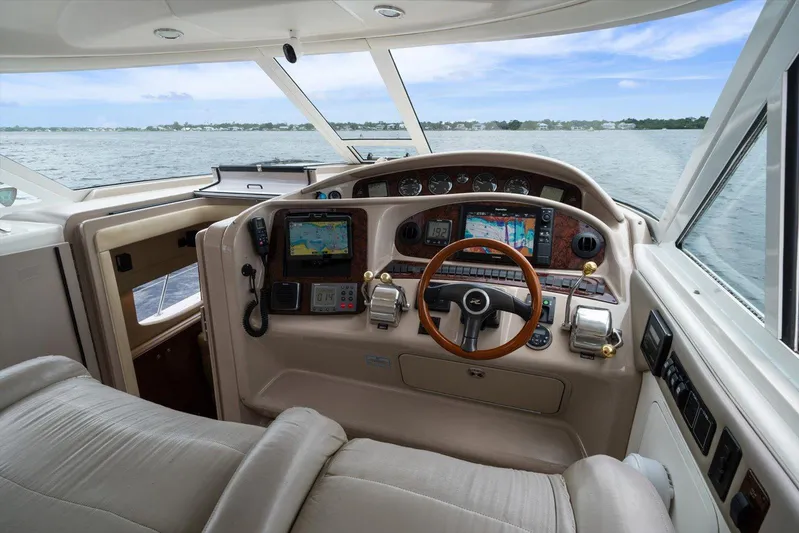 Free Bird Yacht Photos Pics 2003 Sea Ray 480 Motor Yacht helm with navigation equipment and ocean view.