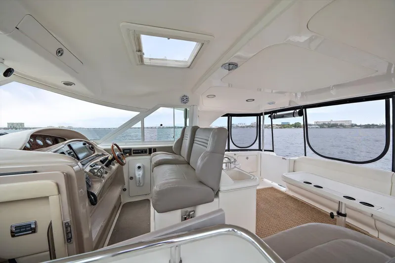 Free Bird Yacht Photos Pics 2003 Sea Ray 480 Motor Yacht interior with helm, leather seating, and panoramic windows overlooking water.