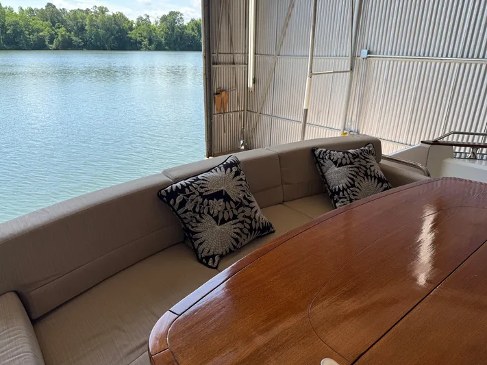 Rebellion Yacht Photos Pics Luxurious seating area on 2012 Monte Carlo Yachts 76, overlooking serene water view.