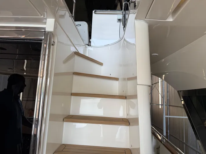 Rebellion Yacht Photos Pics Staircase on 2012 Monte Carlo Yachts 76, featuring sleek design and wooden steps.