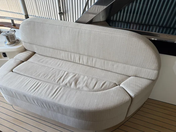 Rebellion Yacht Photos Pics Beige cushioned seating on 2012 Monte Carlo Yachts 76 deck.