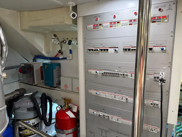 Rebellion Yacht Photos Pics Electrical control panel in 2012 Monte Carlo Yachts 76 engine room, featuring safety equipment.