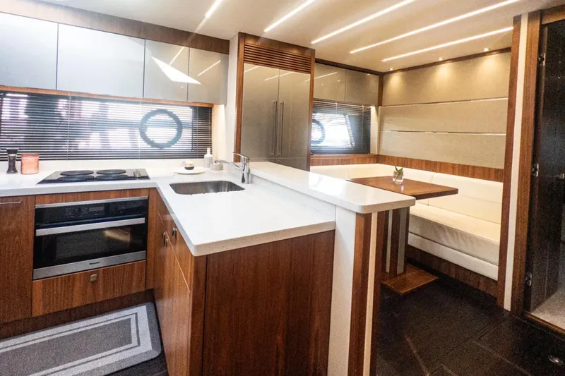  Yacht Photos Pics Luxurious interior of 2020 Sunseeker Predator 74 yacht with modern kitchen and dining area.