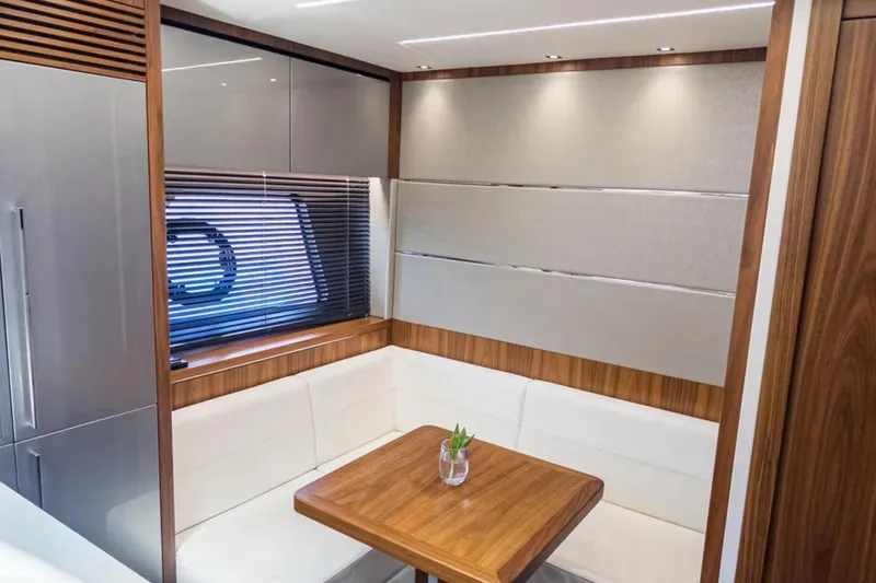  Yacht Photos Pics Luxurious interior of 2020 Sunseeker Predator 74 yacht with elegant seating and wooden accents.