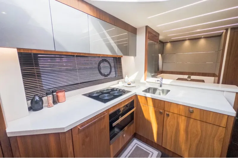  Yacht Photos Pics Luxurious kitchen interior of 2020 Sunseeker Predator 74 yacht with modern design.