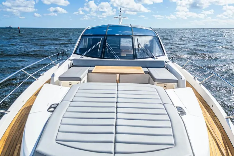  Yacht Photos Pics 2020 Sunseeker Predator 74 yacht on open sea, featuring luxurious deck seating.