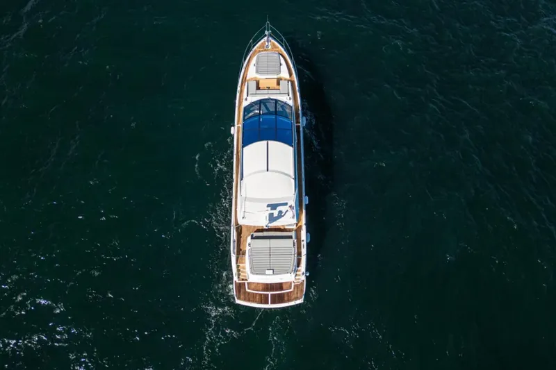  Yacht Photos Pics Aerial view of 2020 Sunseeker Predator 74 yacht cruising on open water.