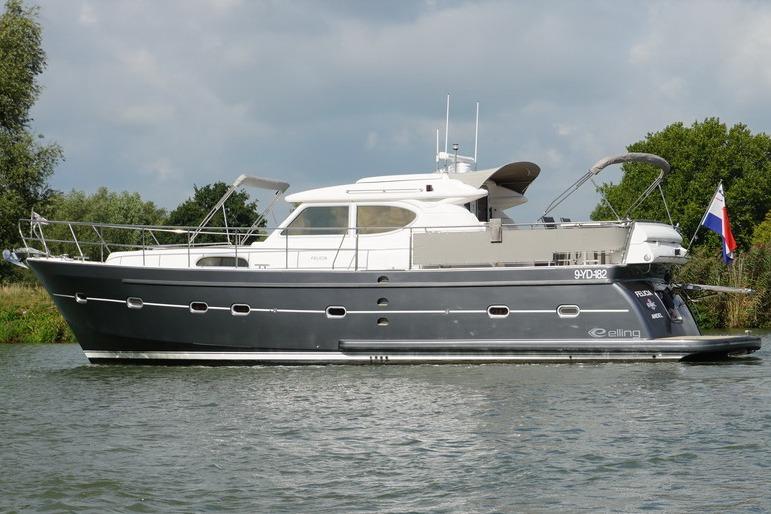 2014 Elling E4 yacht on a calm river, showcasing sleek design and modern features.