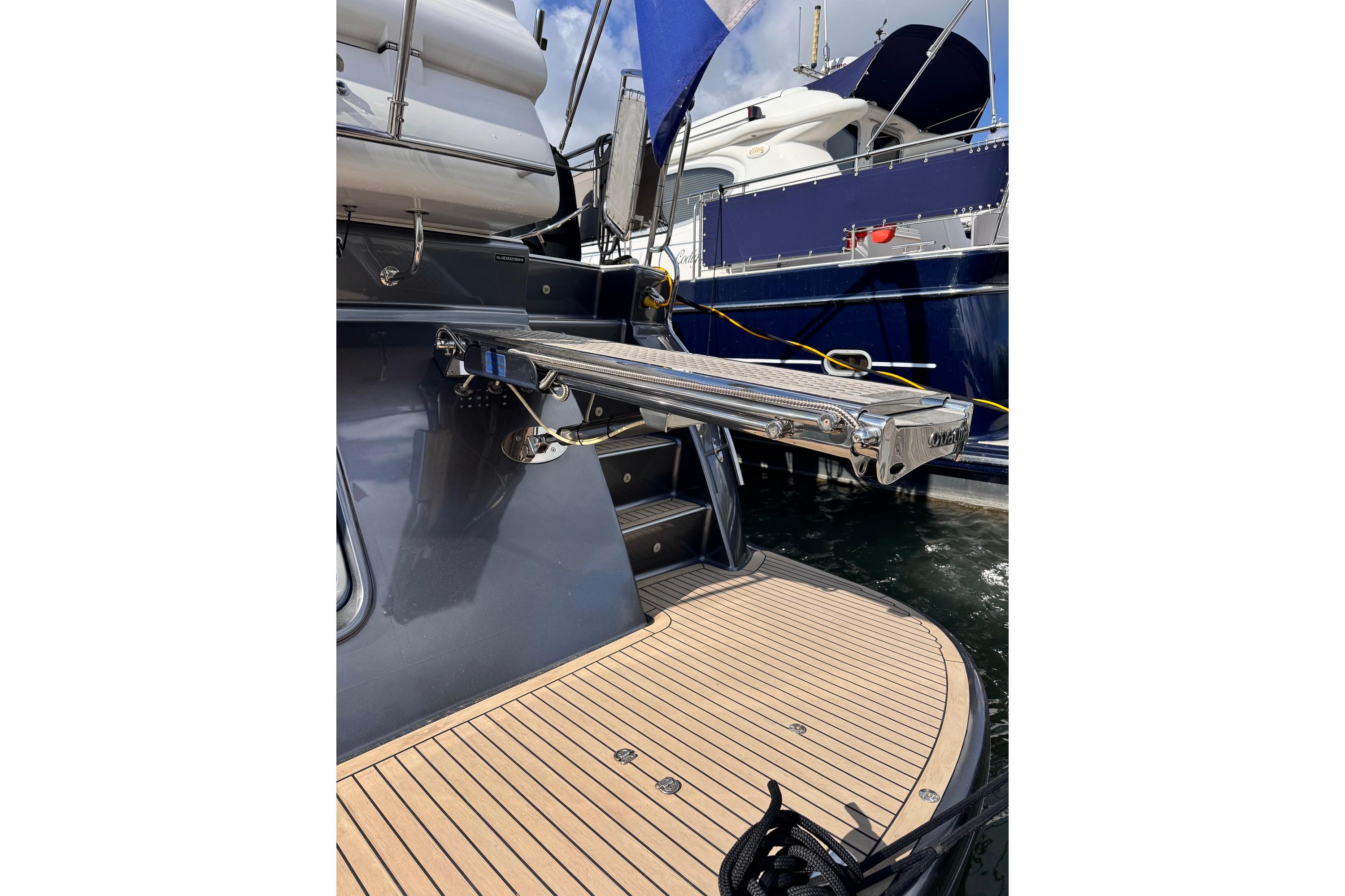 Elling E4 2014 yacht with extended gangway and teak deck at marina.