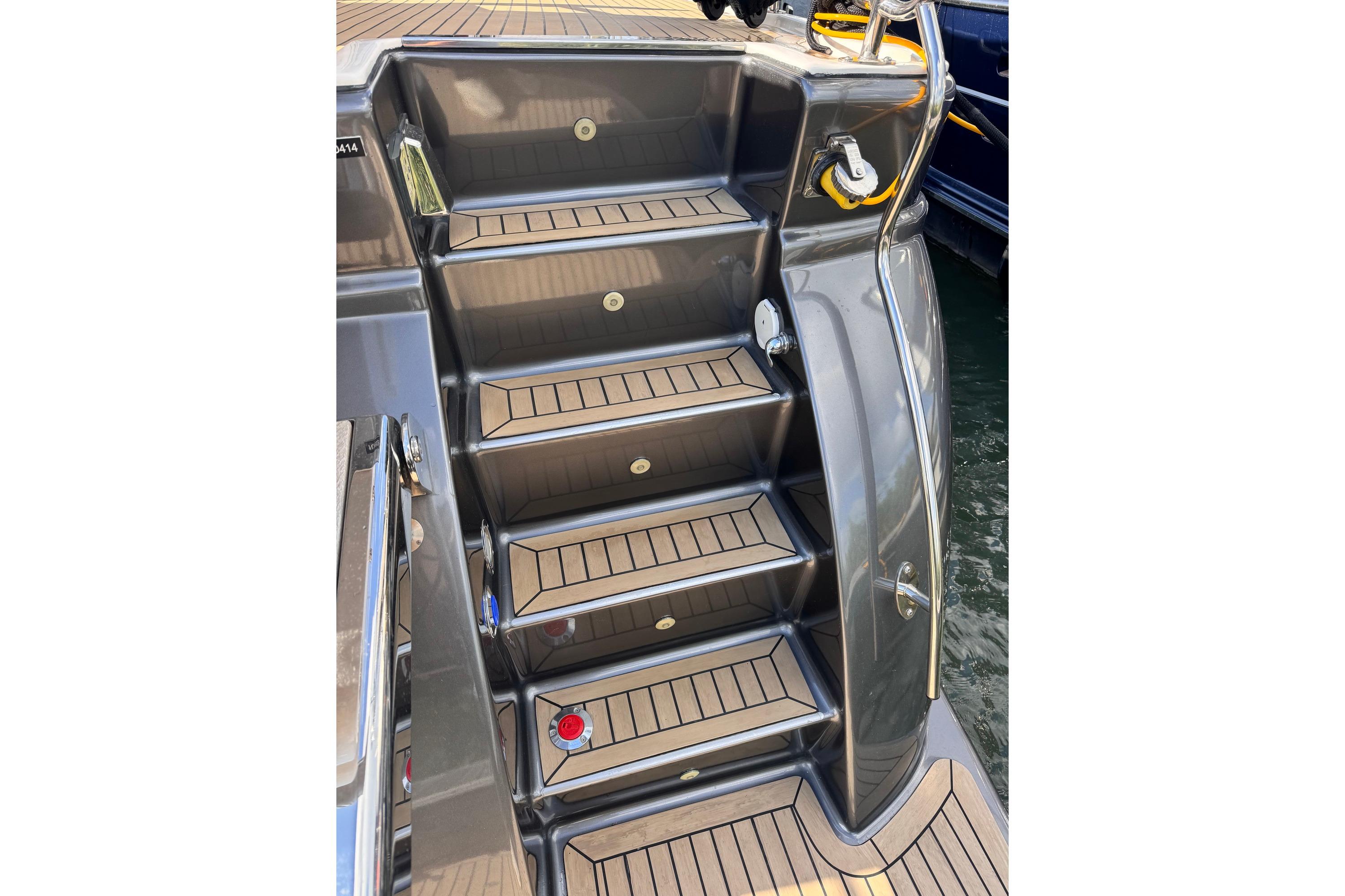 Staircase on 2014 Elling E4 yacht with sleek design and wooden steps.
