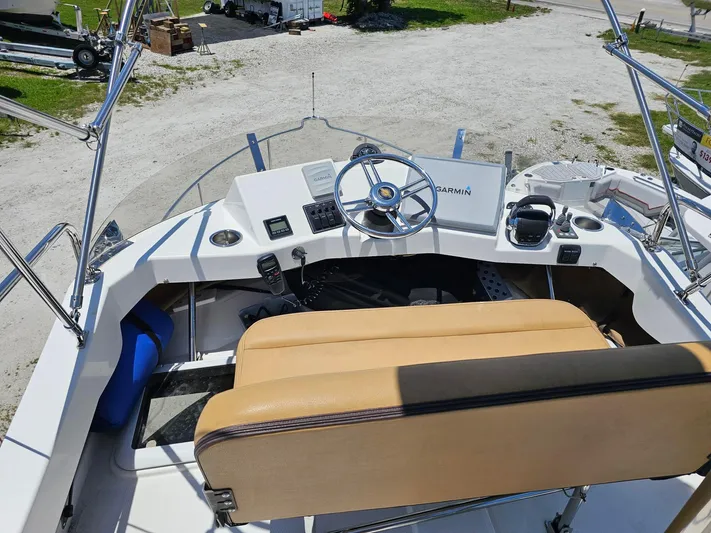  Yacht Photos Pics 2014 Ranger Tugs 31-CB helm with Garmin navigation, beige seating, and steering wheel.