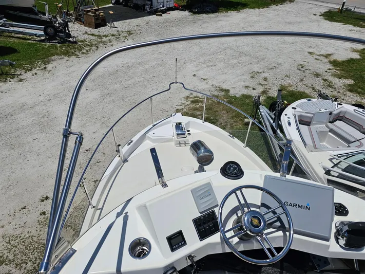 Yacht Photos Pics 2014 Ranger Tugs 31-CB boat helm with Garmin navigation system, docked on gravel.