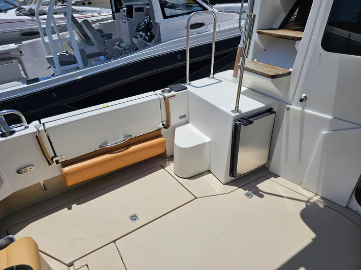  Yacht Photos Pics 2014 Ranger Tugs 31-CB boat interior with seating, steps, and mini fridge.