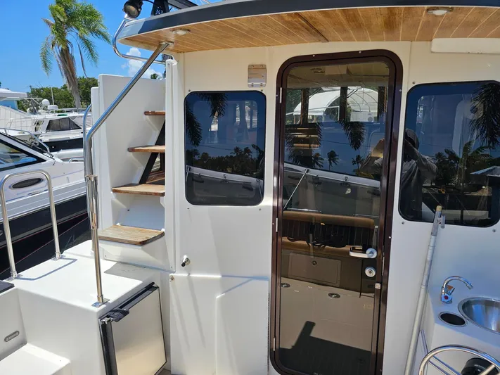  Yacht Photos Pics 2014 Ranger Tugs 31-CB boat exterior with stairs, door, and sink in marina setting.