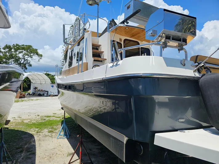  Yacht Photos Pics 2014 Ranger Tugs 31-CB boat on stands, outdoor setting, clear sky background.