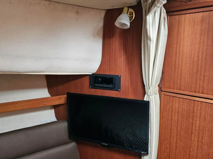  Yacht Photos Pics Interior of 2014 Ranger Tugs 31-CB with TV, wood paneling, and curtain.