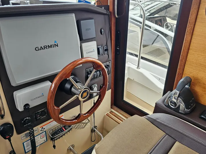  Yacht Photos Pics 2014 Ranger Tugs 31-CB helm with Garmin navigation and wooden steering wheel.