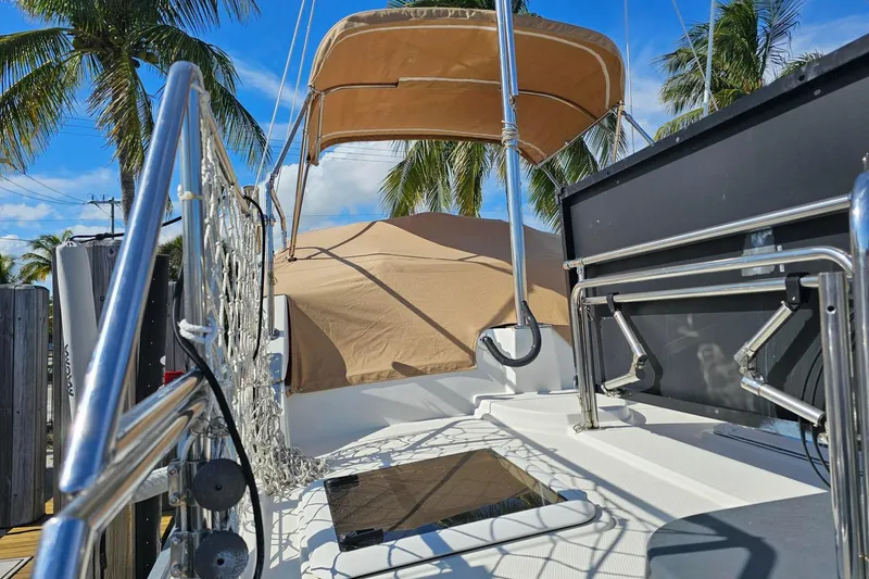  Yacht Photos Pics 2014 Ranger Tugs R 31 boat deck with canopy, surrounded by palm trees.