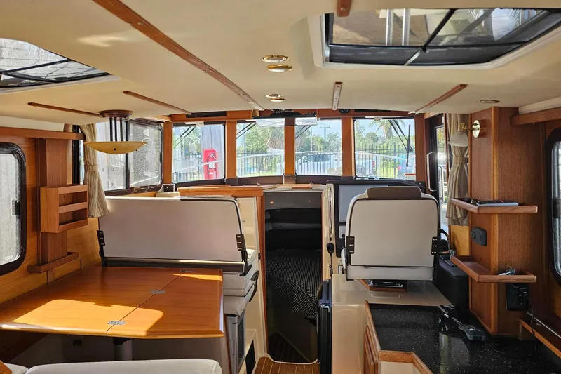  Yacht Photos Pics Interior of 2014 Ranger Tugs R 31 boat, featuring wood accents and seating area.