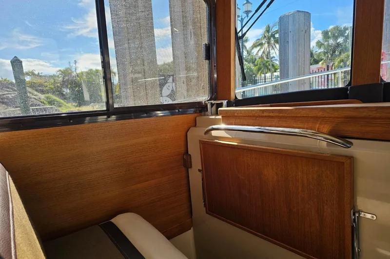  Yacht Photos Pics Interior view of 2014 Ranger Tugs R 31 boat with wooden paneling and window.