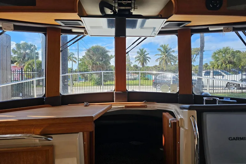  Yacht Photos Pics Interior view of 2014 Ranger Tugs R 31 boat with large windows and wooden accents.