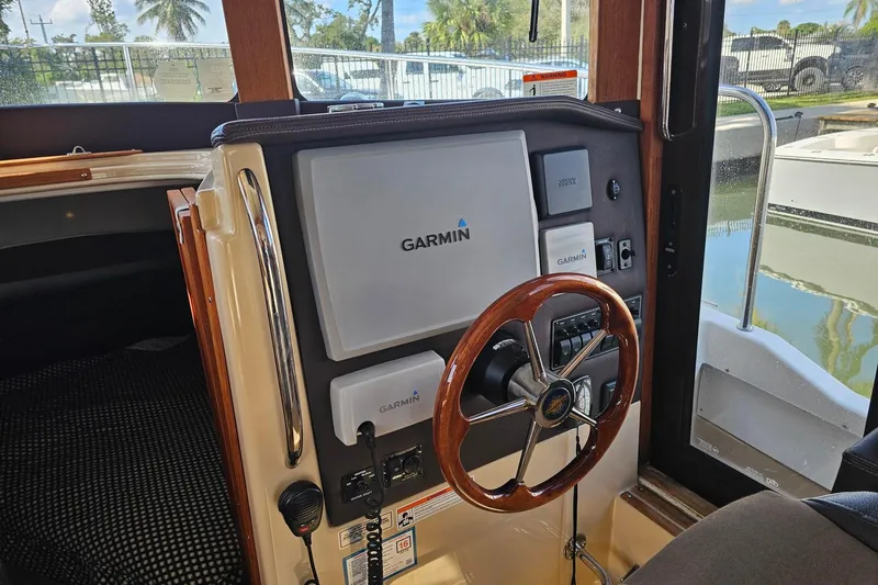  Yacht Photos Pics 2014 Ranger Tugs R 31 helm with Garmin navigation system and wooden steering wheel.